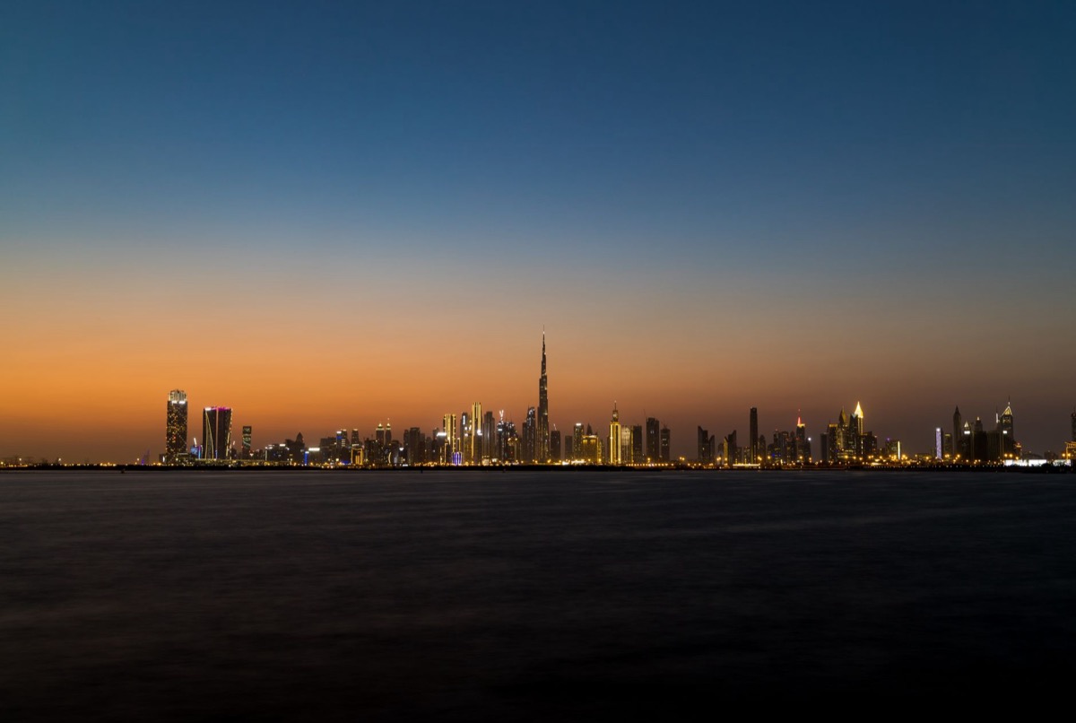The Dubai skyline at twilight featuring the Burj Khalifa.