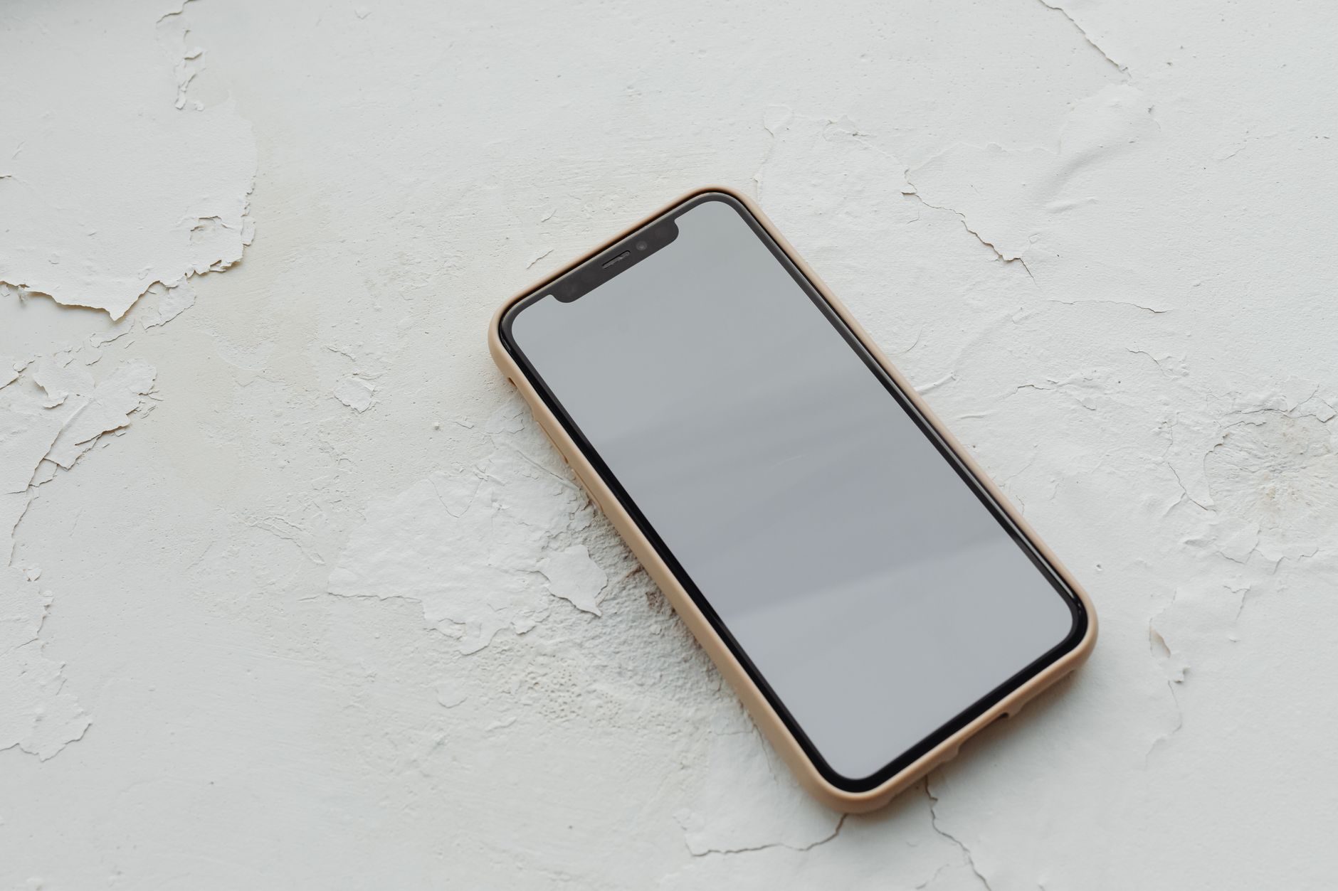 A smartphone with a cracked screen, representing a defective or dead-on-arrival unit in a wholesale lot.