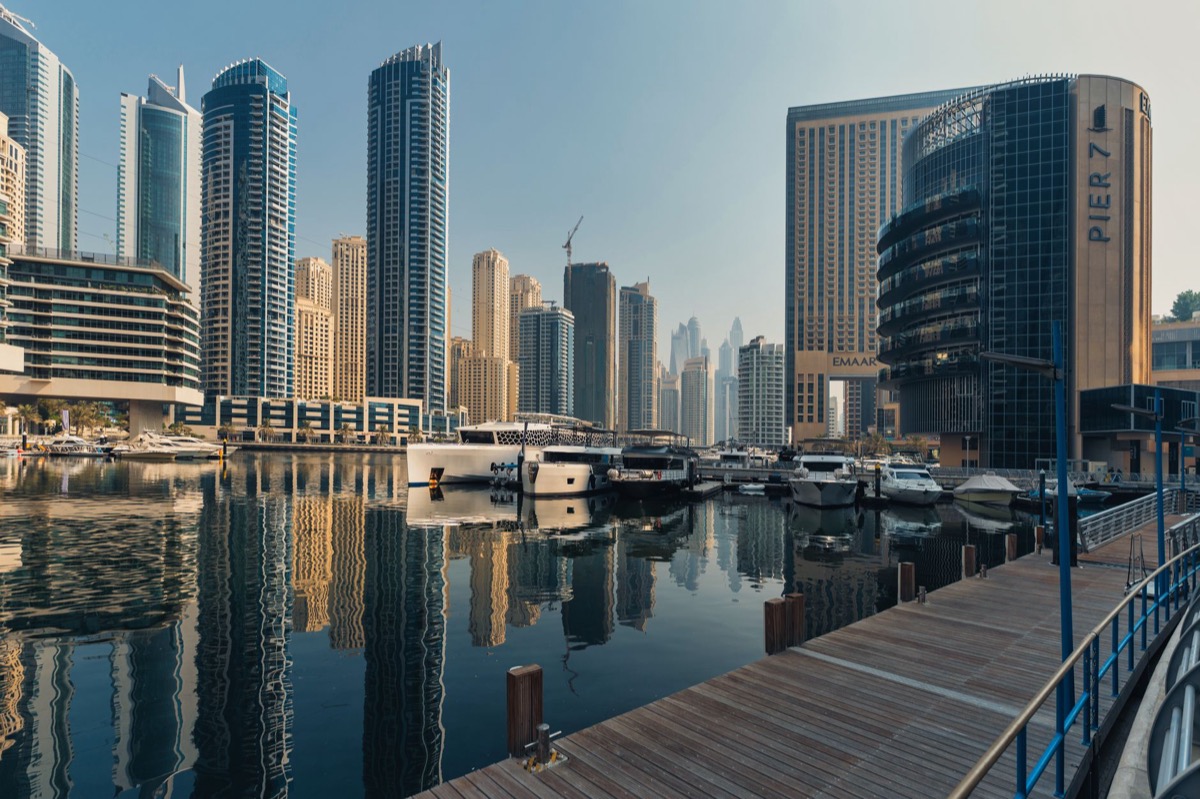 The Dubai Marina skyline with iconic skyscrapers and luxury yachts.