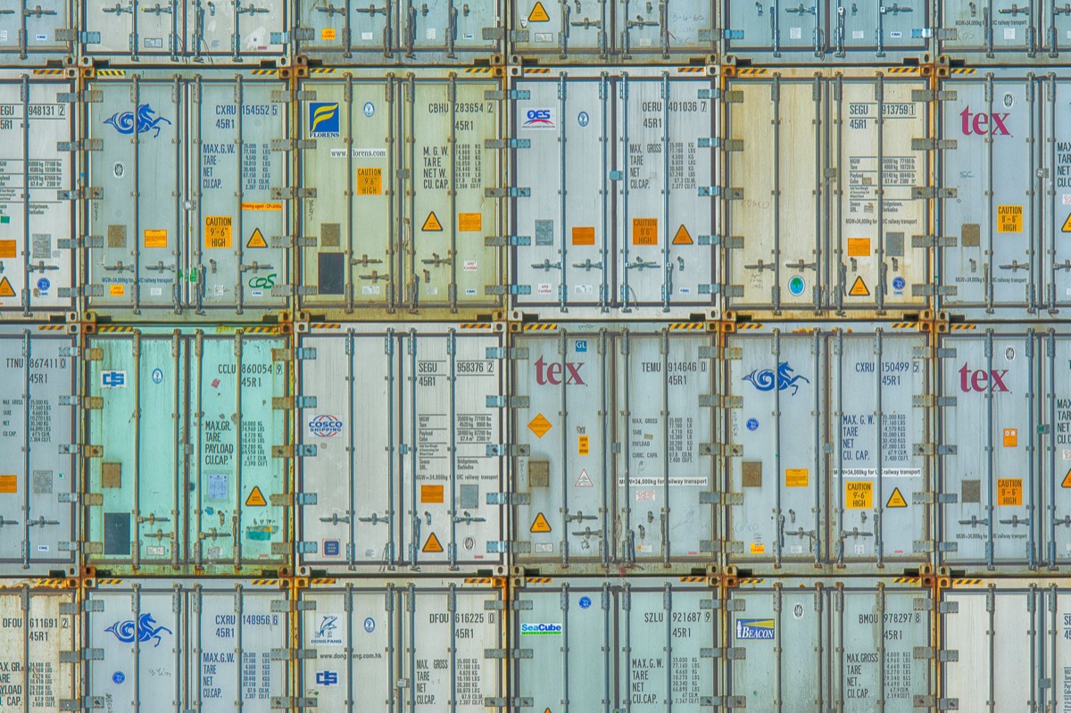 A vibrant display of stacked shipping containers at a port.