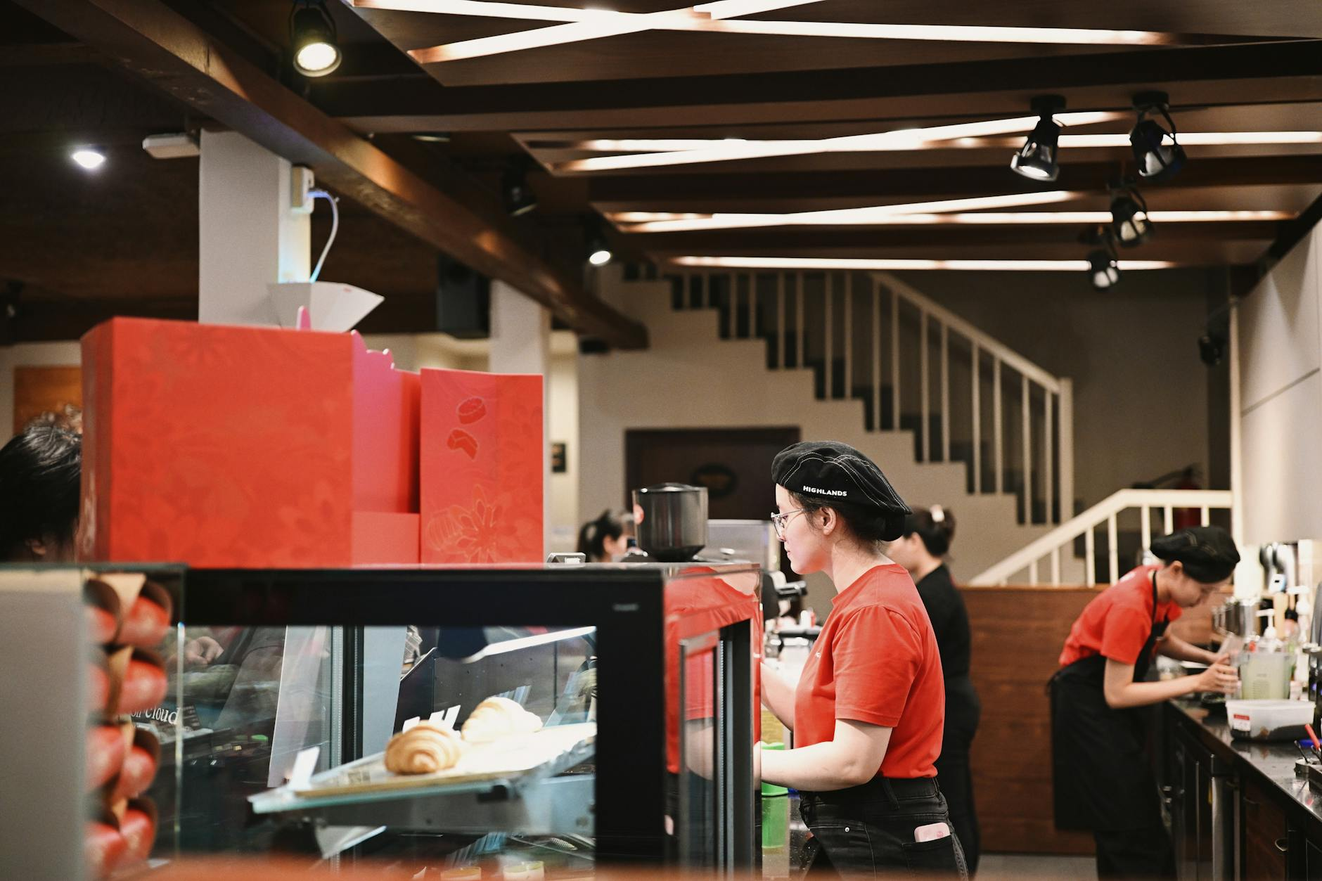 Phone shop counter with staff serving customers, illustrating a retail distribution point.