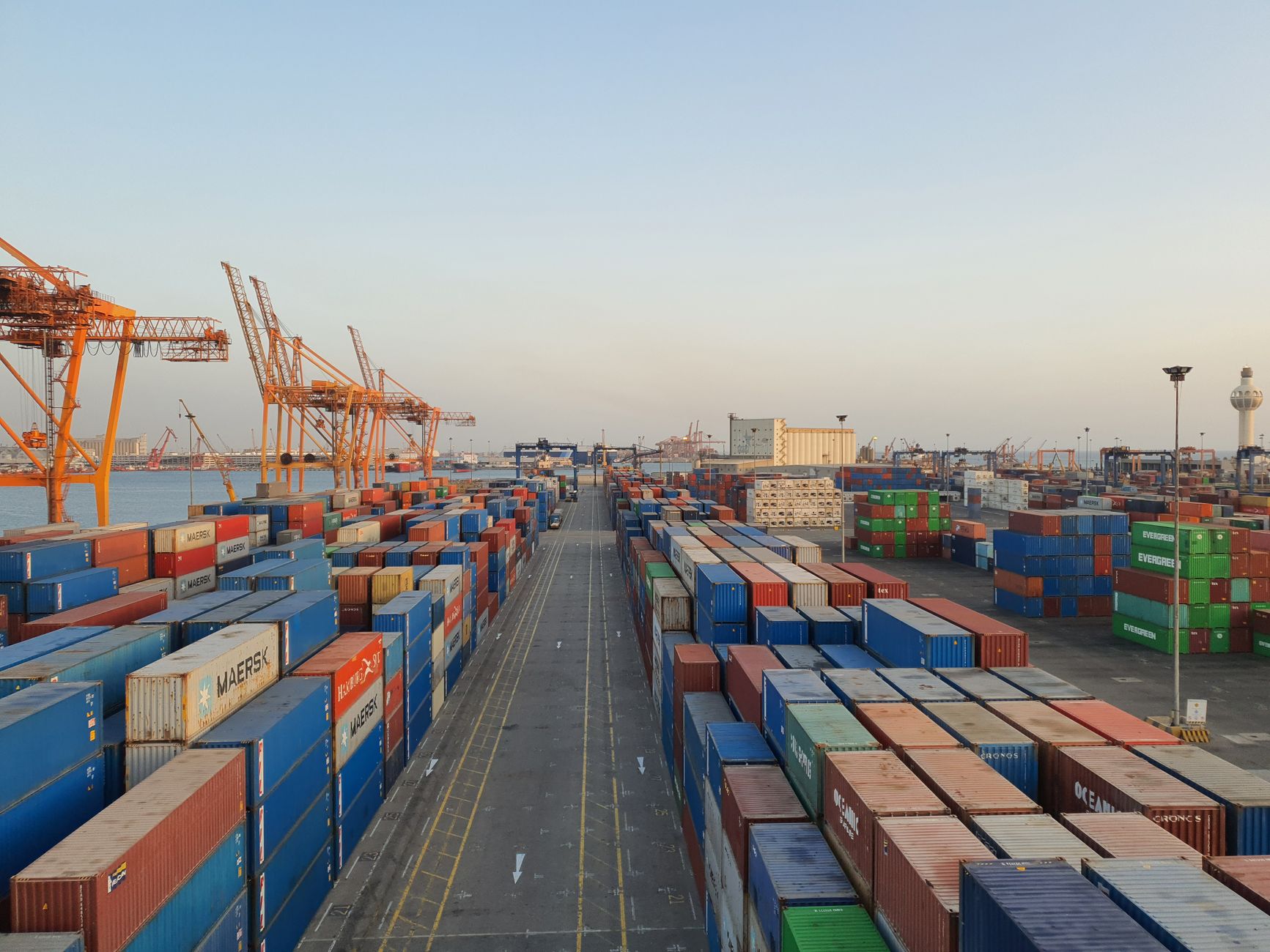 Colorful shipping containers stacked at a cargo port.