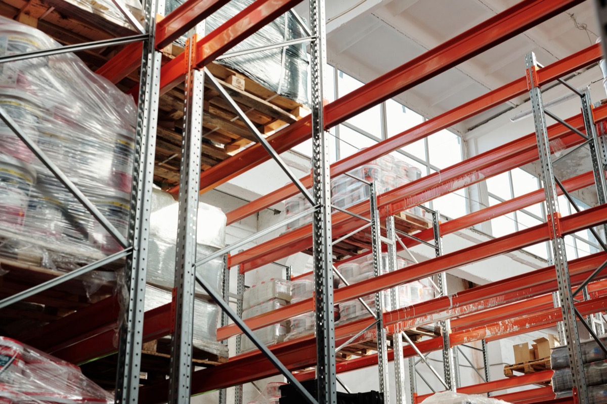 A bright modern warehouse with pallets and storage racks for wholesale inventory.