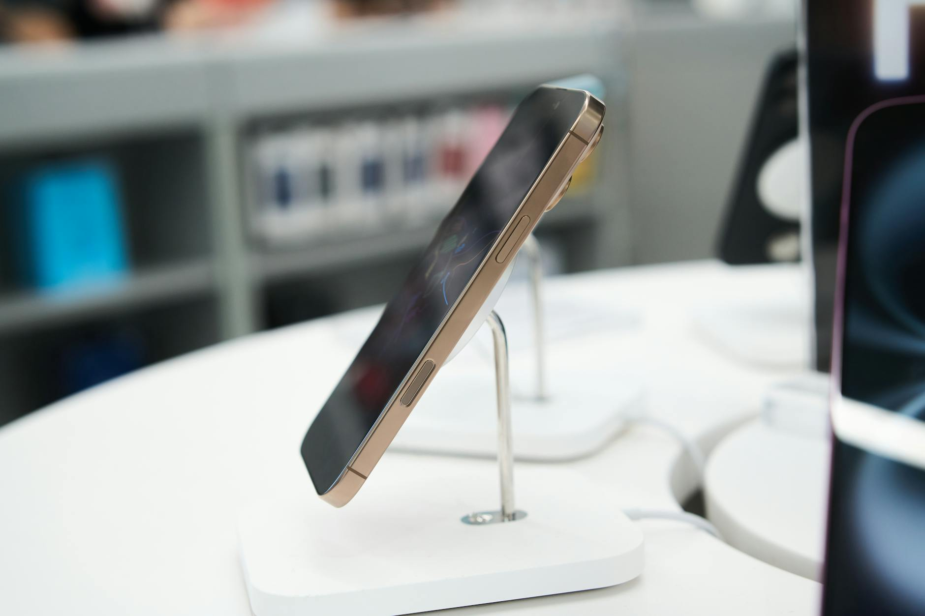 Smartphones on display in a retail counter, illustrating the channel rotation of previous-generation iPhone stock through wholesale and reta