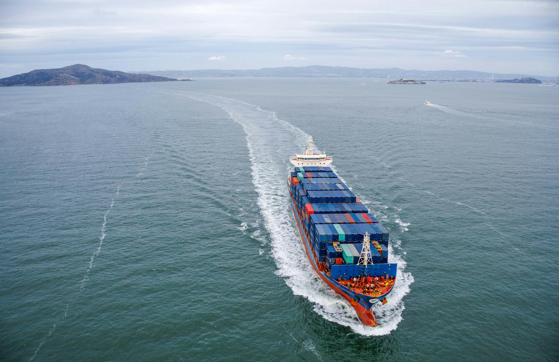 Aerial view of a container ship moving through ocean waters, illustrating the Red Sea shipping routes that reshape wholesale electronics flo