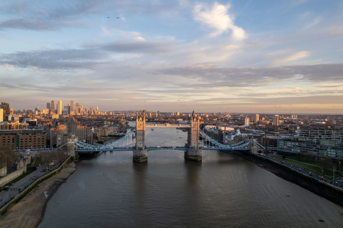 An aerial shot of London's Tower Bridge with the city skyline at dusk.