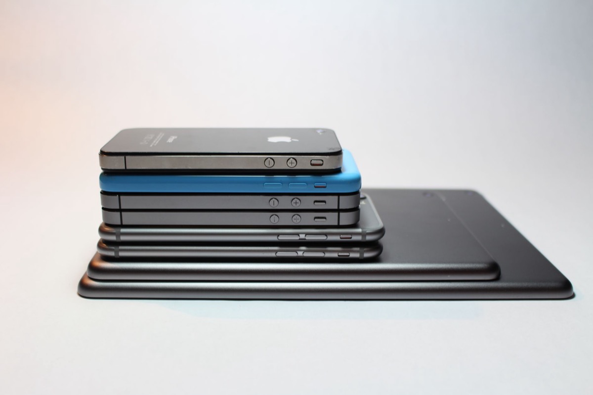 A stack of modern smartphones and tablets showcasing sleek device design.